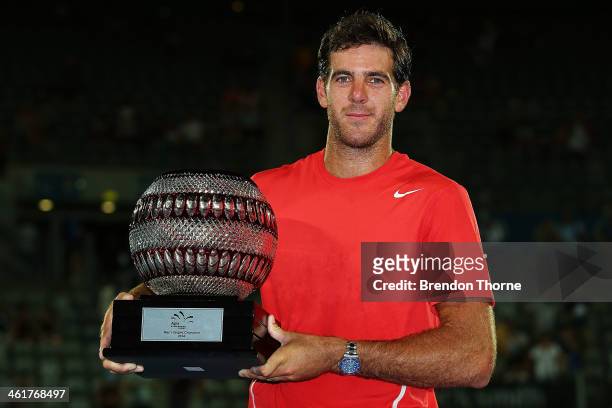 Juan Martin Del Potro of Argentina poses with the trophy after winning the mens singles final against BernardTomic of Australia during day seven of...