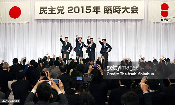 Newly elected Democratic Party President Katsuya Okada raise his fist along with candidates Goshi Hosono and Akira Nagatsuma and outgoing president...