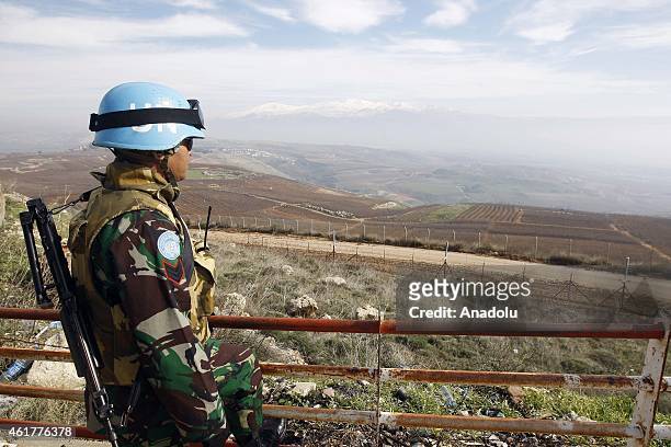 Peacekeeper of the United Nations Interim Force in Lebanon stands guard in the southern Lebanese town of Adaisseh, near the border with Israel, on...