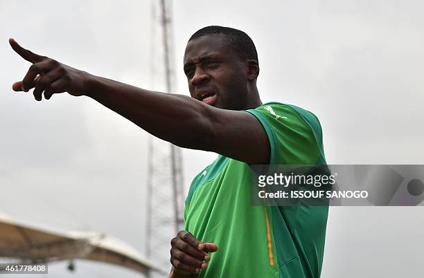 Ivory Coast's midfielder Yaya Toure gestures prior to a training session at Malabo stadium, on the eve of the team's first match as part of the 2015...