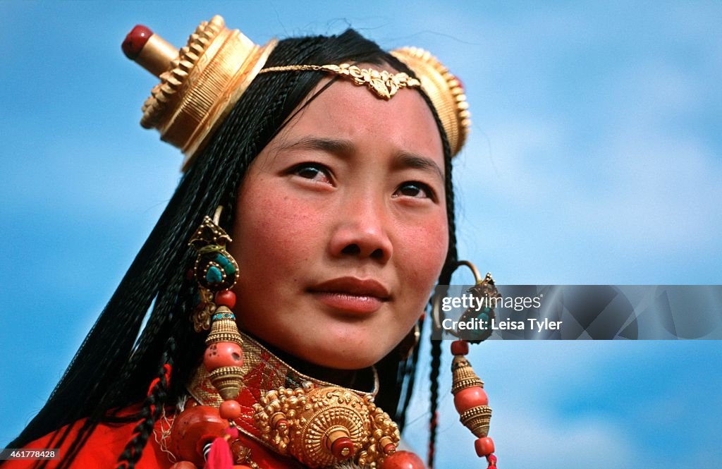 Nomadic Khampa woman wearing exotic headwear at a festival...