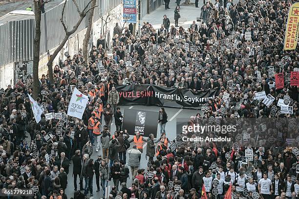 People hold banners and posters during a commemoration ceremony following a march on the 8th death anniversary of Hrant Dink, former editor-in-chief...