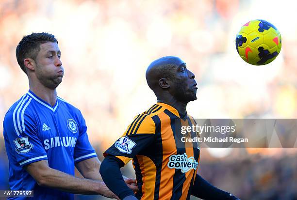 Gary Cahill of Chelsea and Yannick Sagbo of Hull City compete for the ball during the Barclays Premier League match between Hull City and Chelsea at...