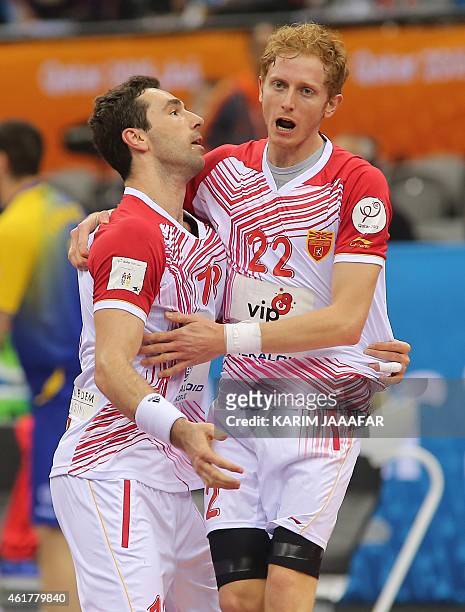Macedonia's Filip Mirkulovski celebrates with teammate Goce Georgievski during the 24th Men's Handball World Championships preliminary round Group B...
