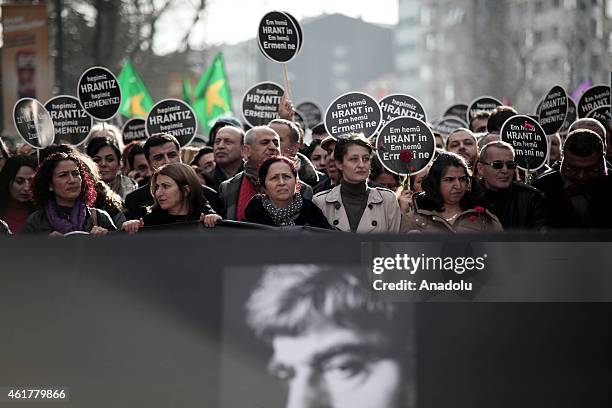 People hold banners and posters during a commemoration ceremony following a march on the 8th death anniversary of Hrant Dink, former editor-in-chief...