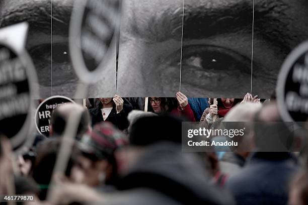 People hold banners and posters during a commemoration ceremony following a march on the 8th death anniversary of Hrant Dink, former editor-in-chief...