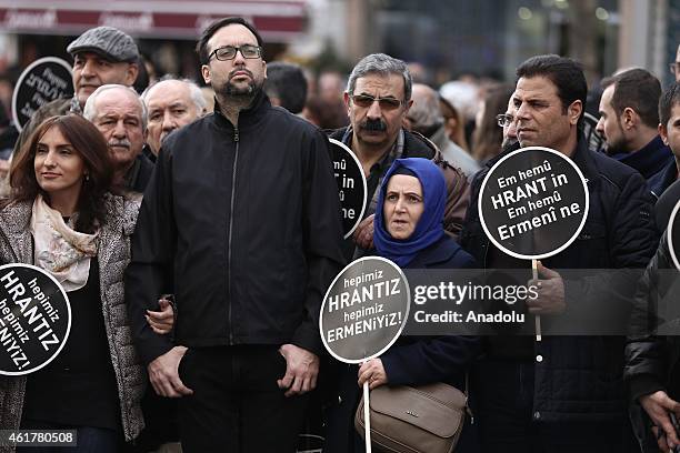 People hold banners and posters during a commemoration ceremony following a march on the 8th death anniversary of Hrant Dink, former editor-in-chief...