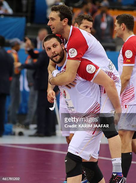 Macedonia's Filip Mirkulovski celebrates with his teammate after winning their 24th Men's Handball World Championships preliminary round Group B...