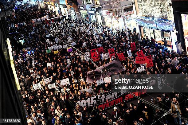People hold a banner reading during a march in memory of slain journalist Hrant Dink, on Istiklal avenue in Istanbul on January 19, 2015. Turkish...