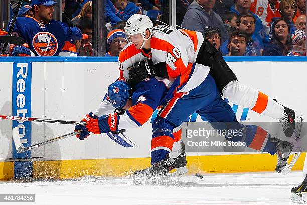 Calvin de Haan of the New York Islanders is checked by Vincent Lecavalier of the Philadelphia Flyers at Nassau Veterans Memorial Coliseum on January...