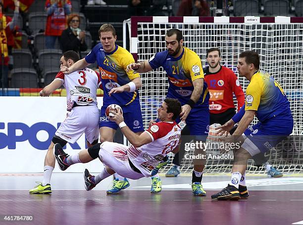 Macedonia's Filip Mirkulovski in action against his opponent during the 24th Men's Handball World Championship's preliminary round Group B match...