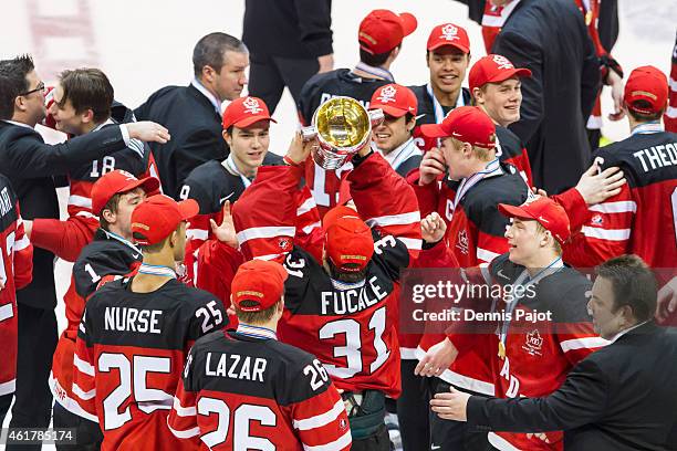 Team Canada celebrates with the trophy after a 5-4 win against Russia during the Gold medal game of the 2015 IIHF World Junior Championship on...