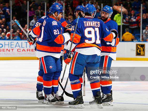 Nick Leddy of the New York Islanders is congratulated by his teammates after scoring a third period goal against the Philadelphia Flyers at Nassau...