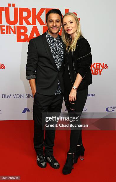 Kostja Ullmann and Janin Reinhardt pose on the red carpet during the '3 Tuerken & Ein Baby' Berlin premiere on January 19, 2015 in Berlin, Germany.