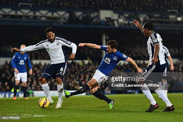 Leighton Baines of Everton shoots at goal under pressure from Joleon Lescott and Andre Wisdom of West Brom during the Barclays Premier League match...