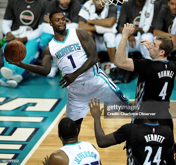 Charlotte Hornets guard Lance Stephenson looks to pass to a teammate as Minnesota Timberwolves forward Robbie Hummel and forward Anthony Bennett...