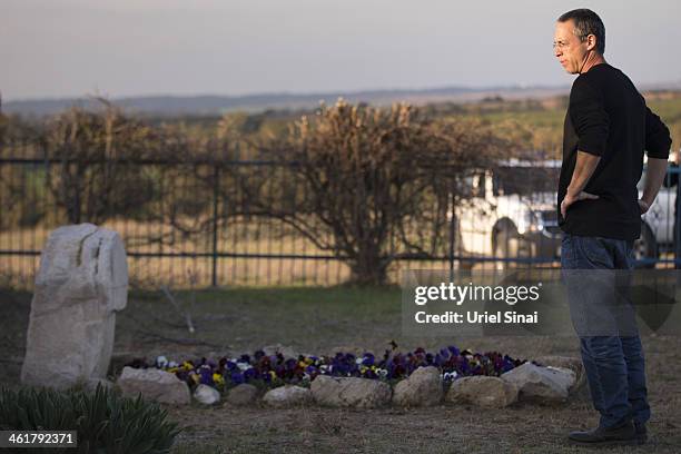 Gilad Sharon, the son of former PM Ariel Sharon, visits the grave of his mother Lili were his father is expected to be buried after the announcement...