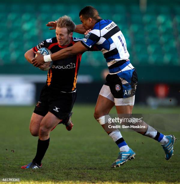 Ashley Smith of Newport is tackled by Anthony Watson of Bath during the Amlin Challenge Cup match between Newport Gwent Dragons and Bath at Rodney...