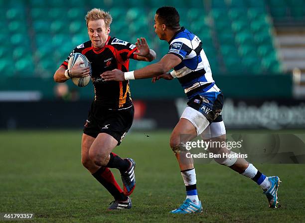 Ashley Smith of Newport is tackled by Anthony Watson of Bath during the Amlin Challenge Cup match between Newport Gwent Dragons and Bath at Rodney...