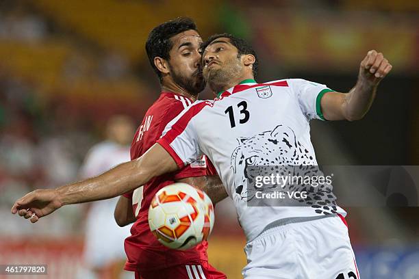 Habib Al Fardan of the United Arab Emirates and Vahid Amiri of Iran compete for the ball during the 2015 Asian Cup match between IR Iran and the UAE...