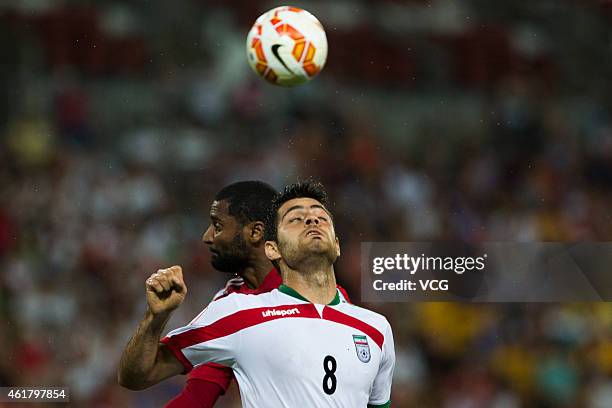 Abdulaziz Sanqour of the United Arab Emirates and Morteza Pouraliganji of Iran compete for the ball during the 2015 Asian Cup match between IR Iran...