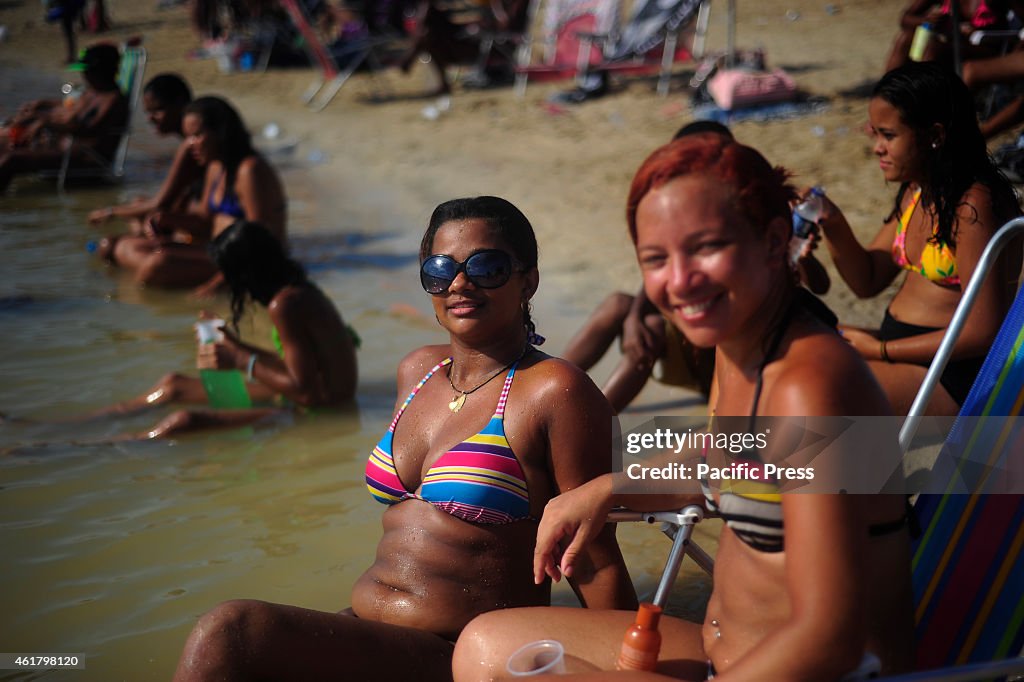 Beach goers enjoy  the waters of  Palm Piscinão, north of...