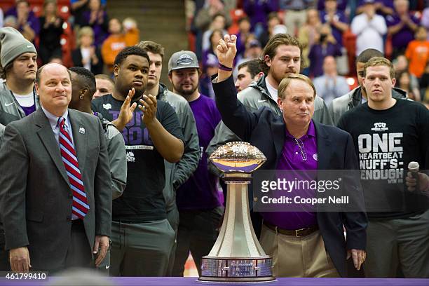 Football head coach Gary Patterson and his team present the Chick-fil-A Peach Bowl trophy during halftime against the Texas Longhorns on January 19,...