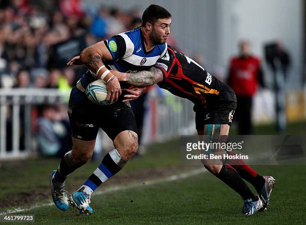 Matt Banahan of Bath is tackled by Dan Evans of Newport during the Amlin Challenge Cup match between Newport Gwent Dragons and Bath at Rodney Parade...