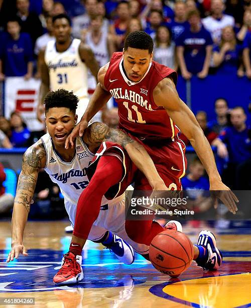 Kelly Oubre Jr. #12 of the Kansas Jayhawks battles Isaiah Cousins of the Oklahoma Sooners for a loose ball during the game at Allen Fieldhouse on...