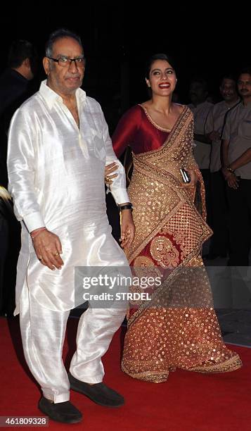 Indian Bollywood actress Kajol Devgn with father in-law Veeru Devgn attend the wedding reception of Kussh Sinha, son of Bollywood veteran actor...