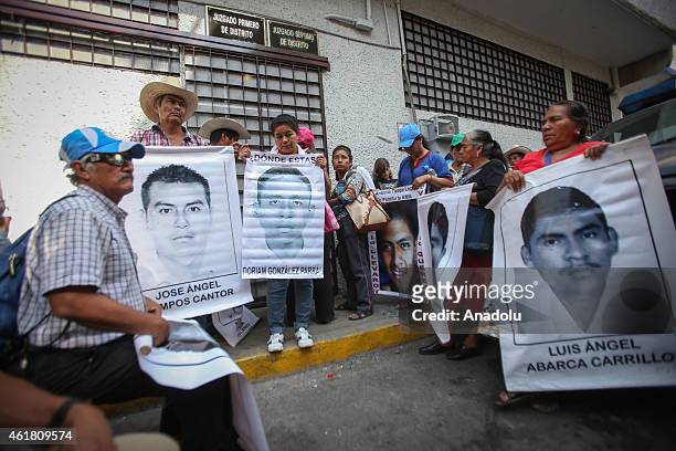 Demonstrators hold portraits during a protest in demand of justice and clarification for the disappearance of 43 students from Ayotzinapa, in...