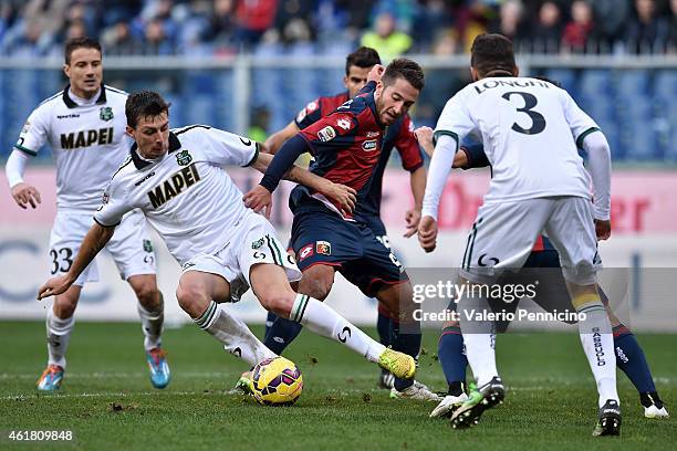 Andrea Bertolacci of Genoa CFC is challenged by Francesco Acerbi of US Sassuolo Calcio during the Serie A match between Genoa CFC and US Sassuolo...