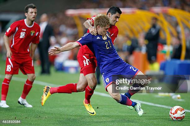 Adballah Deeb of Jordan takes down Gotoku Sakai of Japan during the 2015 Asian Cup match between Japan and Jordan at AAMI Park on January 20, 2015 in...