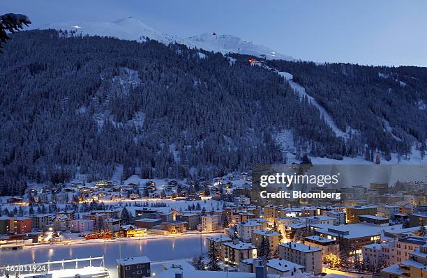 Residential buildings stand illuminated on the town skyline ahead of the World Economic Forum in Davos, Switzerland, on Monday, Jan. 19, 2015. This...