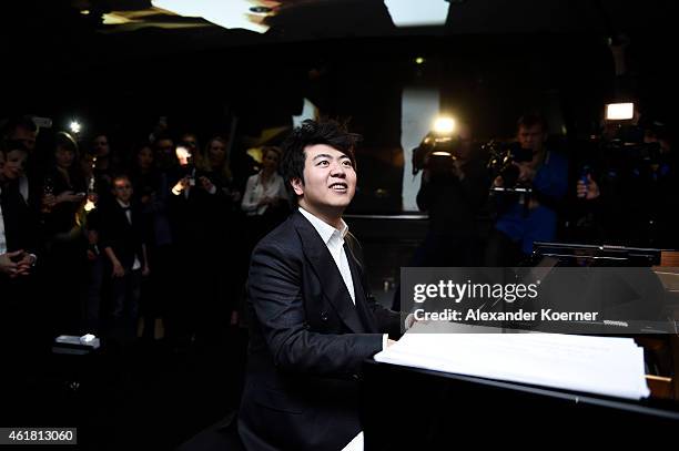 Pianist Lang Lang plays the piano during the 'Amazing Lang Lang' World Premiere Fragrance Launch at Galeries Lafayette on January 19, 2015 in Berlin,...