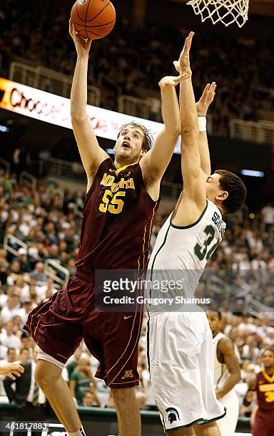 Elliott Eliason of the Minnesota Golden Gophers gets a first half shot off next to Gavin Schilling of the Michigan State Spartans at the Jack T....