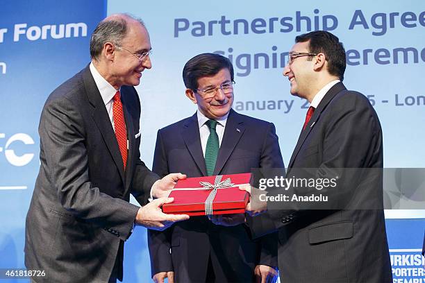 Xavier Rolet, CEO of London Stock Exchange Group presenting a gift to Turkish Prime Minister Ahmet Davutoglu after signing a business partnership...