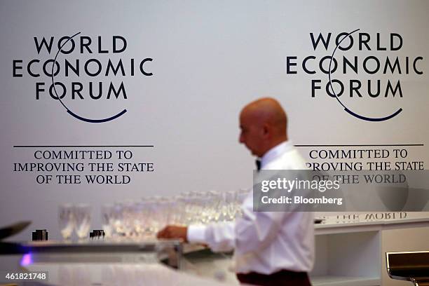 Worker prepares wine glasses in a hospitality area inside the Kongress Zentrum, also known as Congress Center, ahead of the World Economic Forum in...