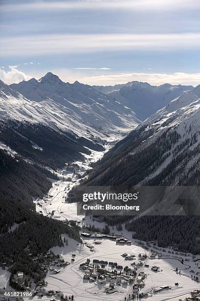 The Pischa, left, and Jakobshorn, right, mountain ranges surround snow-covered chalets in the town of Davos, ahead of the World Economic Forum in...