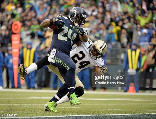 Running back Marshawn Lynch of the Seattle Seahawks scores a touchdown on a 15-yard run in the second quarter against cornerback Corey White of the...