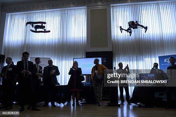 Staff from aerial imaging company DJI, demonstrate a remote control aircraft during a press conference by the Small UAV Coalition January 20, 2015 in...