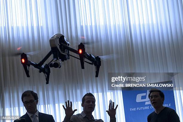 Staff from aerial imaging company DJI, demonstrate a remote control aircraft during a press conference by the Small UAV Coalition January 20, 2015 in...