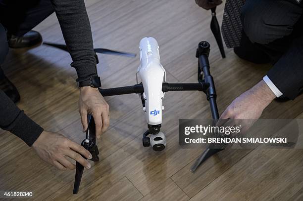 Staff from aerial imaging company DJI, assemble a remote control aircraft during a press conference by the Small UAV Coalition January 20, 2015 in...