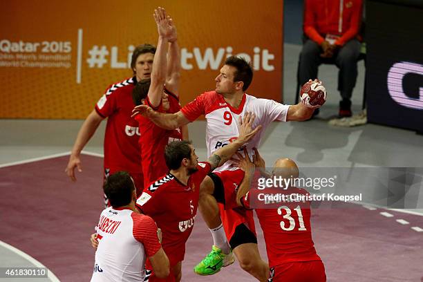 Alexander Pyshkin of Russia and Timur Dibirov of Russia defend against Andrzej Rojewski of Poland during the IHF Men's Handball World Championship...