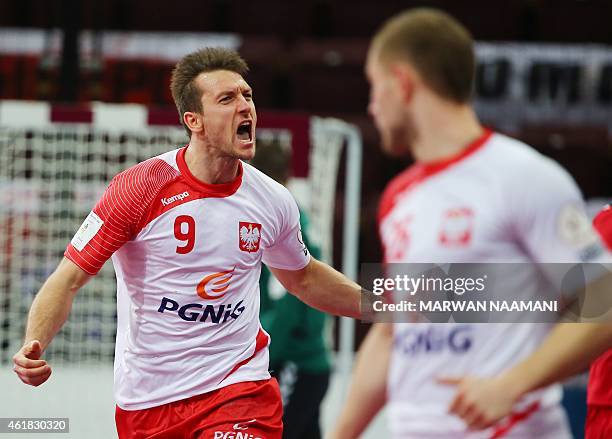 Poland's Andrzej Rojewski celebrates after scoring a goal during the 24th Men's Handball World Championships preliminary round Group D match between...