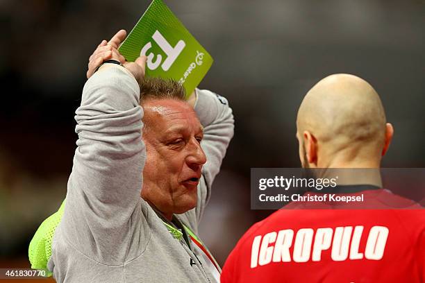 Head coach Michael Biegler of Poland speaks to Konstantin Igropulo of Russia during the IHF Men's Handball World Championship group D match between...