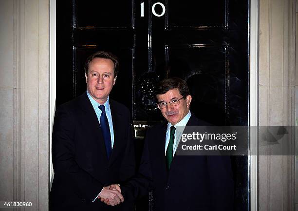 British Prime Minister David Cameron greets Turkey's Prime Minister Ahmet Davutoglu on January 20, 2015 in Downing Street in London, England. The...