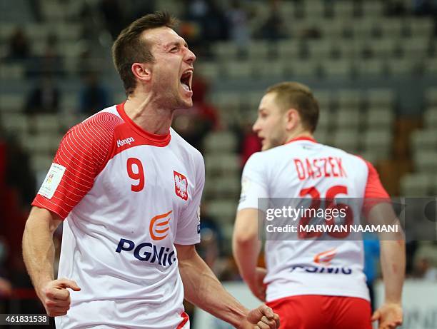 Poland's Andrzej Rojewski celebrates during the 24th Men's Handball World Championships preliminary round Group D match between Poland and Russia at...