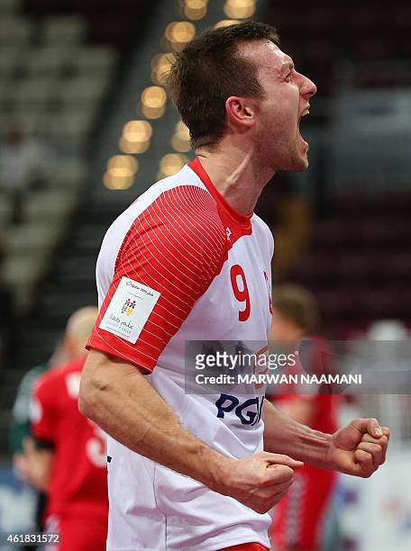 Poland's Andrzej Rojewski celebrates during the 24th Men's Handball World Championships preliminary round Group D match between Poland and Russia at...