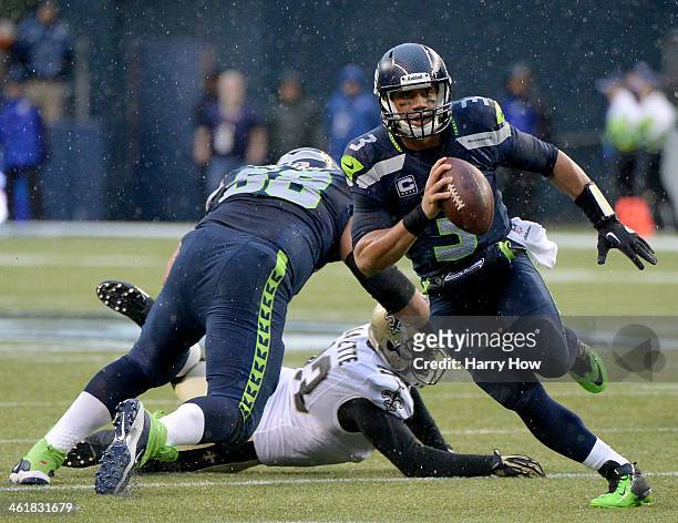 Quarterback Russell Wilson of the Seattle Seahawks runs the ball against the New Orleans Saints in the second quarter during the NFC Divisional...